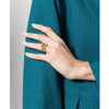 Woman in Teal Blazer wearing 18K Gold plated Double Knot Ring on ring finger. 