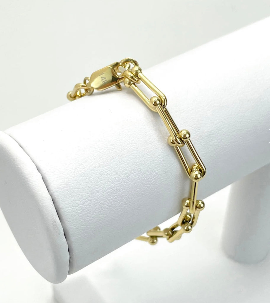 18K Gold Filled U Link Bracelet on white stand.