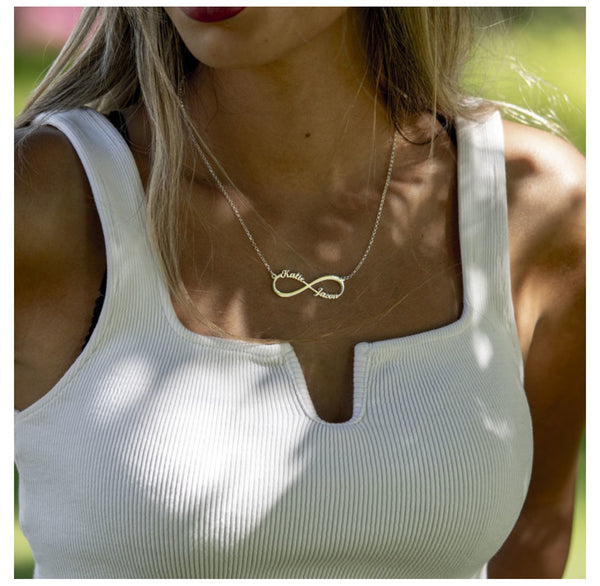 Woman wearing personalized infinity necklace with two names. 