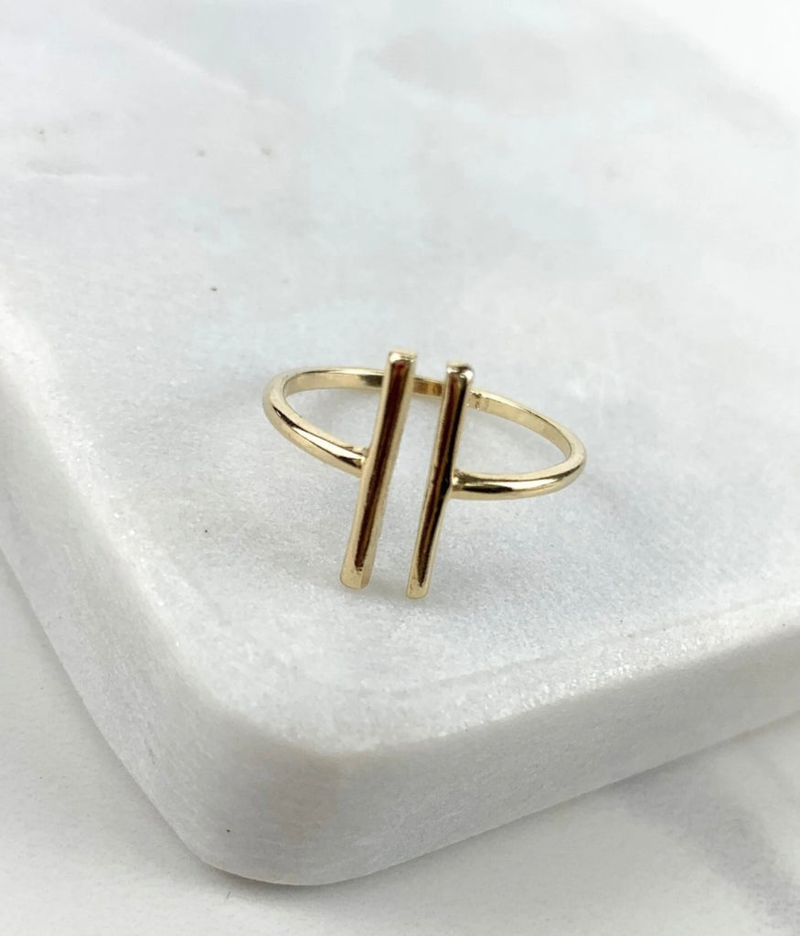 Close up of open adjustable 18K gold filled bar ring on a coaster.