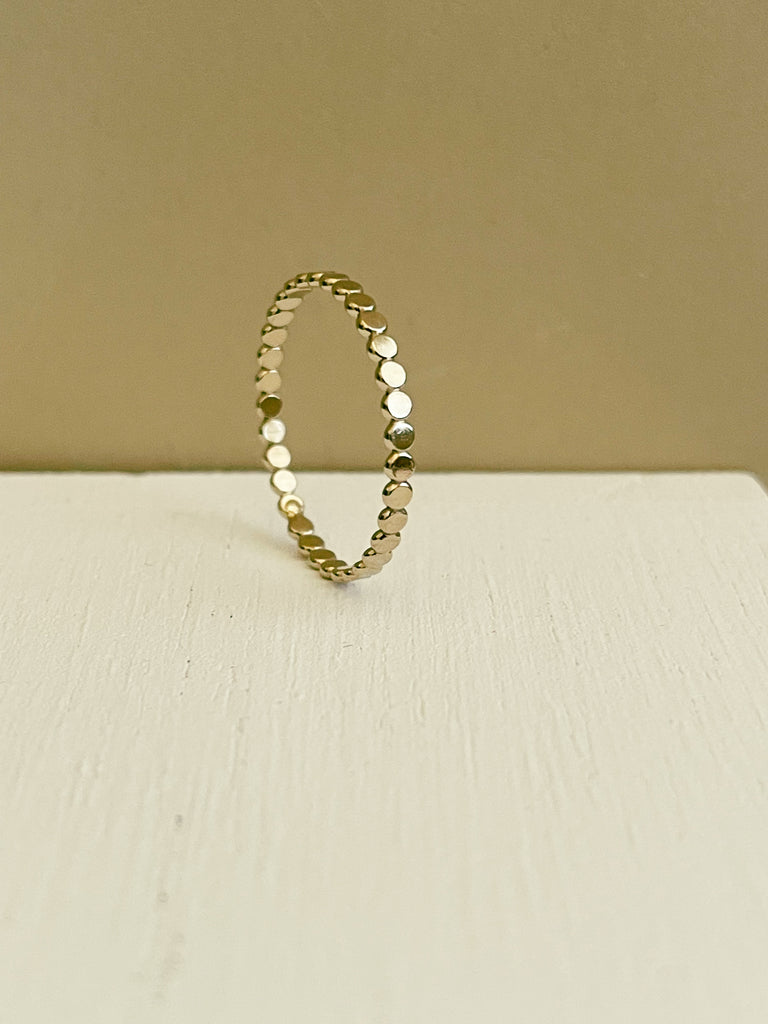 gold filled Flat disc band with cream background.