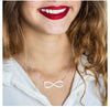 Woman wearing personalized infinity necklace with two names.