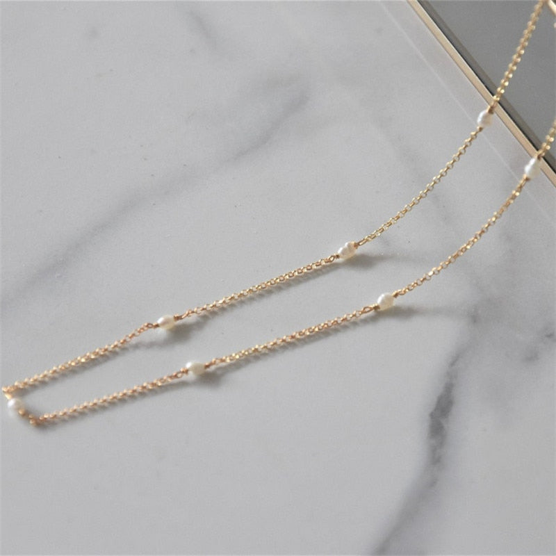 14K Gold Filled Single Pearl Pattern Necklace against marble.