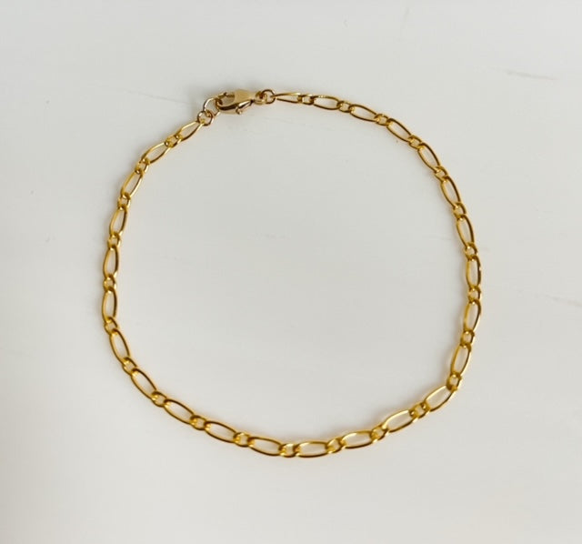 Gold filled Classic Chain Link Bracelet on neutral background.