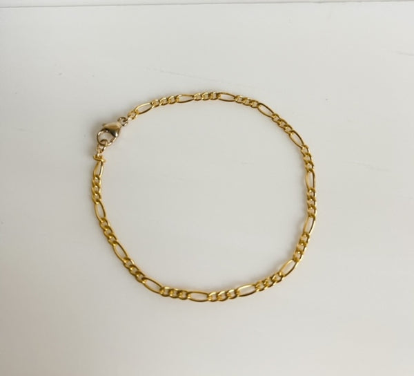 14K gold filled Thin Figaro Bracelet on white background.