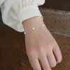 Woman with white blouse wearing 925 Sterling Pearl Bracelet 