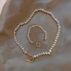 Parure of Pearls Bracelet and necklace laying on a satin sheet from NAZ Parure