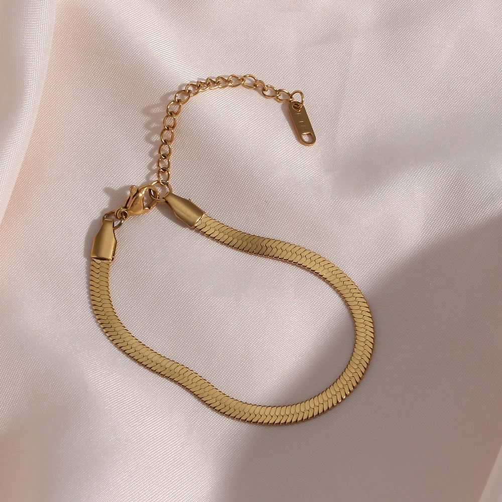 Close up of the snake-like details on our Herringbone Gold Bracelet.