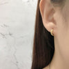 Leaves of Gold Earrings on woman with brown hair. 