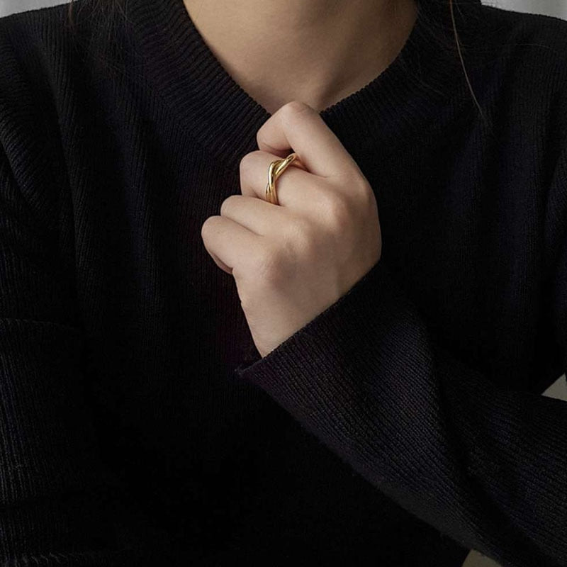 Woman with black sweater wearing Twist ring on middle finger from NAZ Parure