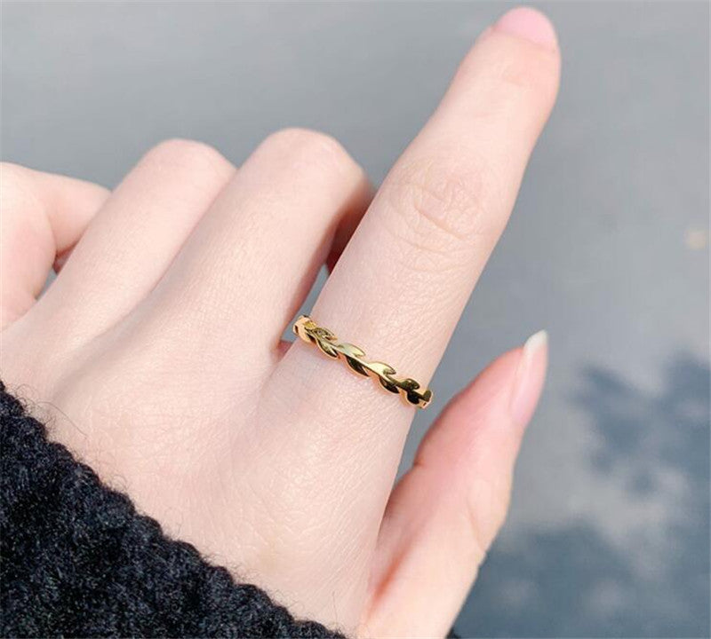 Woman with black sweater wearing Gold Leaves Ring from NAZ Parure.
