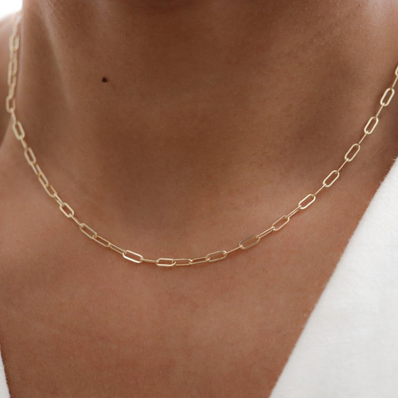 Woman in white low cut blouse wearing 14K Gold-Filled Oval Link Chain.