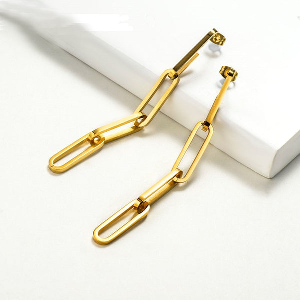 closeup of Paperclip Chain Earrings resting on white background