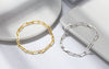 Sterling Silver and Gold Filled Paperclip Chain Bracelets laying against white coasters.
