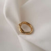 18K Gold plated Twist Ring against satin fabric.