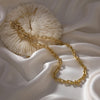 Bold Gold Chain against fabric and cream pillow