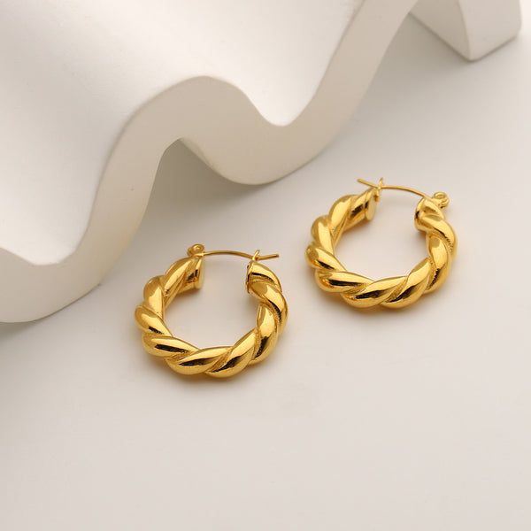 18K gold plated Classic Twist Hoops against a geometric background.