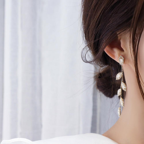 Woman with Updo wearing Gold Leaves on Vine Earrings from NAZ Parure.