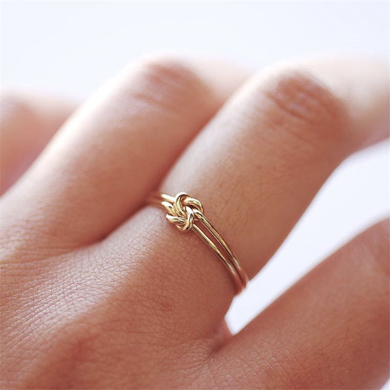 Middle finger wearing gold-filled knot ring suitable to wear while working out or showering. 