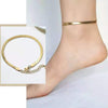 Woman wearing 18K gold plated Herringbone Anklet while barefoot.
