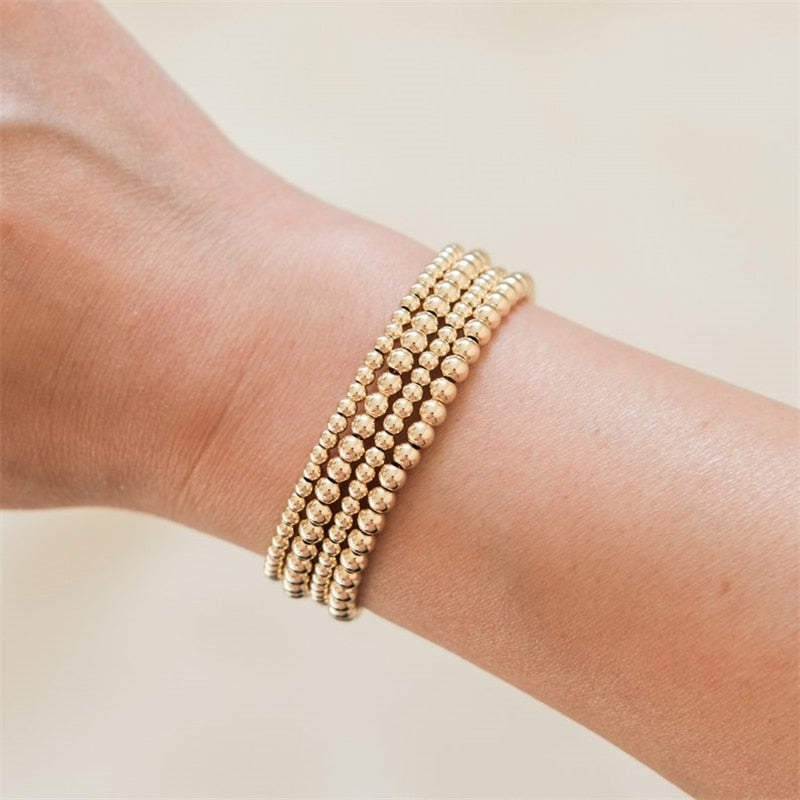 Versatile 14K gold-filled bracelets on a wrist which are waterproof and sweatproof