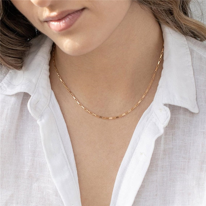 Woman in white linen blouse wearing 14K gold filled Chain Link Necklace.