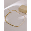 18K Gold plated Rope Chain with Pearls laid out on stone with sun rays casting a shadow.