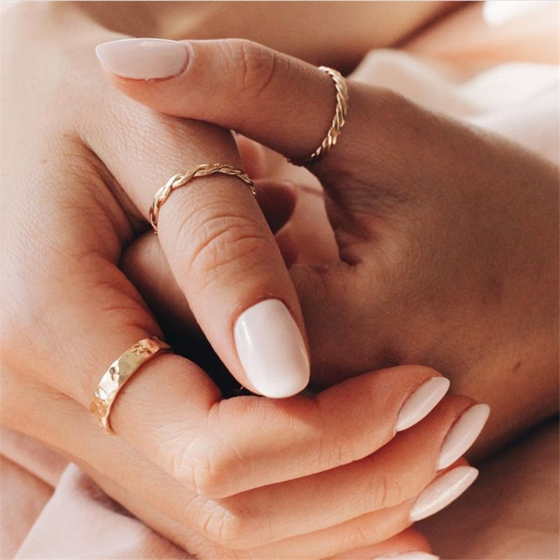 Hand with White Nails wearing 14K Gold-Filled Infinity band and 14K Gold-Filled Thin Braid ring.