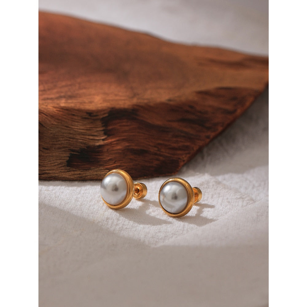 Close up of Pearl with Gold Halo Studs with charcuterie board background.