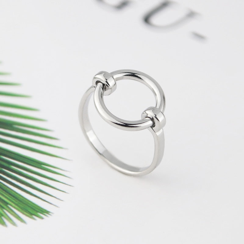 Stainless steel Unity Ring on white background.