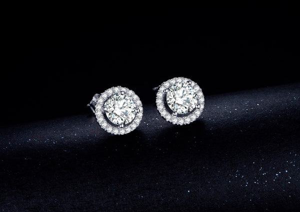 Halo Solitaire Studs on top of black velvet fabric.