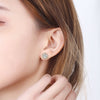 Woan with brown hair wearing 14K Gold plated Rhinestone Halo Studs from NAZ Parure Jewelry.
