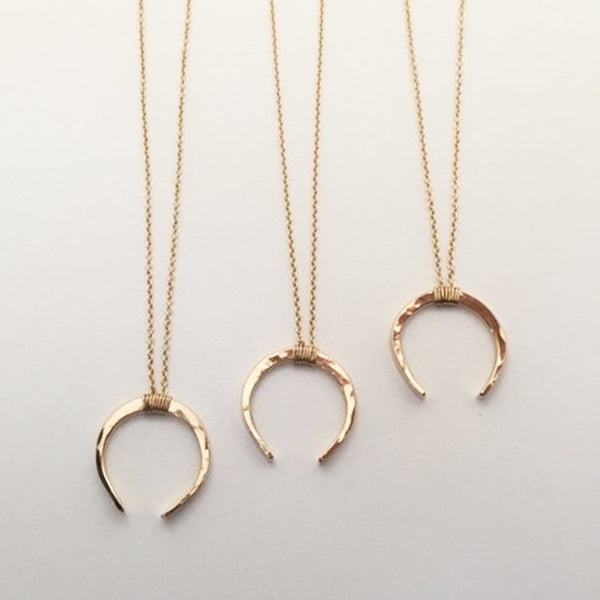 Three Gold Filled Moon Necklaces lined up next to each other. 