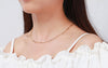 Woman in white ruffle tunic wearing Gold Filled Paperclip Chain