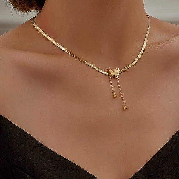 Woman with low cut black blouse wearing 14K gold plated Gold Butterfly Necklace on stainless steel.
