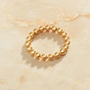 Thick 18K Gold Plated Beads of Gold Ring against marble background.