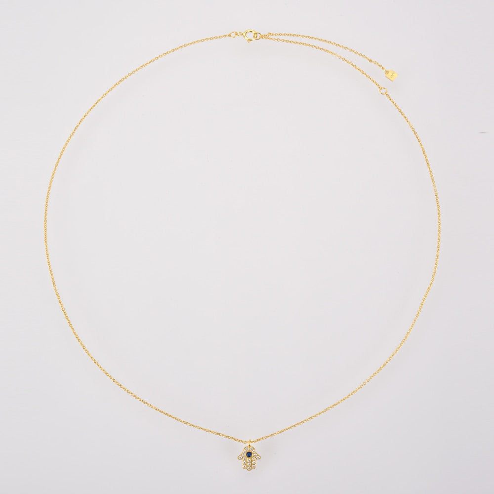 Delicate Gold Plated Hamsa Necklace laid out against a white border.