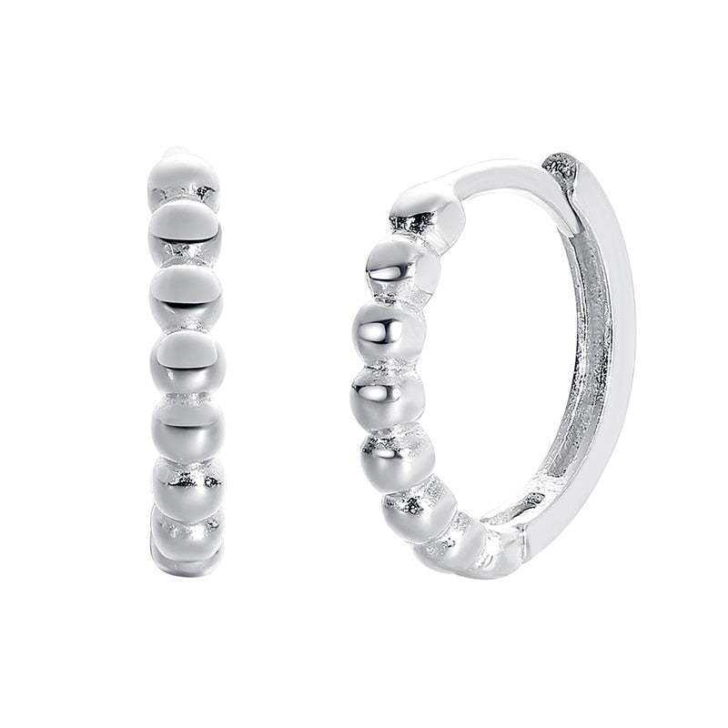 Close up of sterling silver Beads of Love Hoop Earrings on white background.