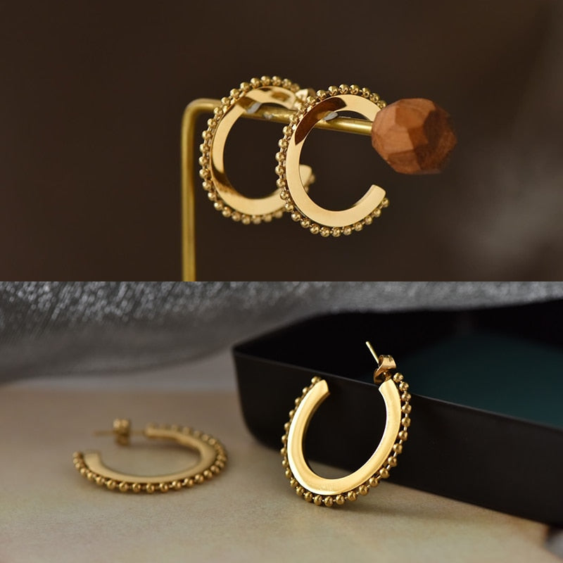 Beaded and Solid Hoop Earrings on an earing stand and resting against a NAZ Parure Jewelry gift box.