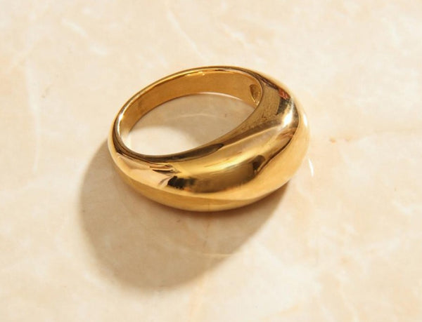 14K Gold-Plated Dome ring against marble background available in size 6, 7, and 8.