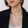 Woman with goat wearing the waterproof Herringbone Necklace from NAZ Parure Jewelry