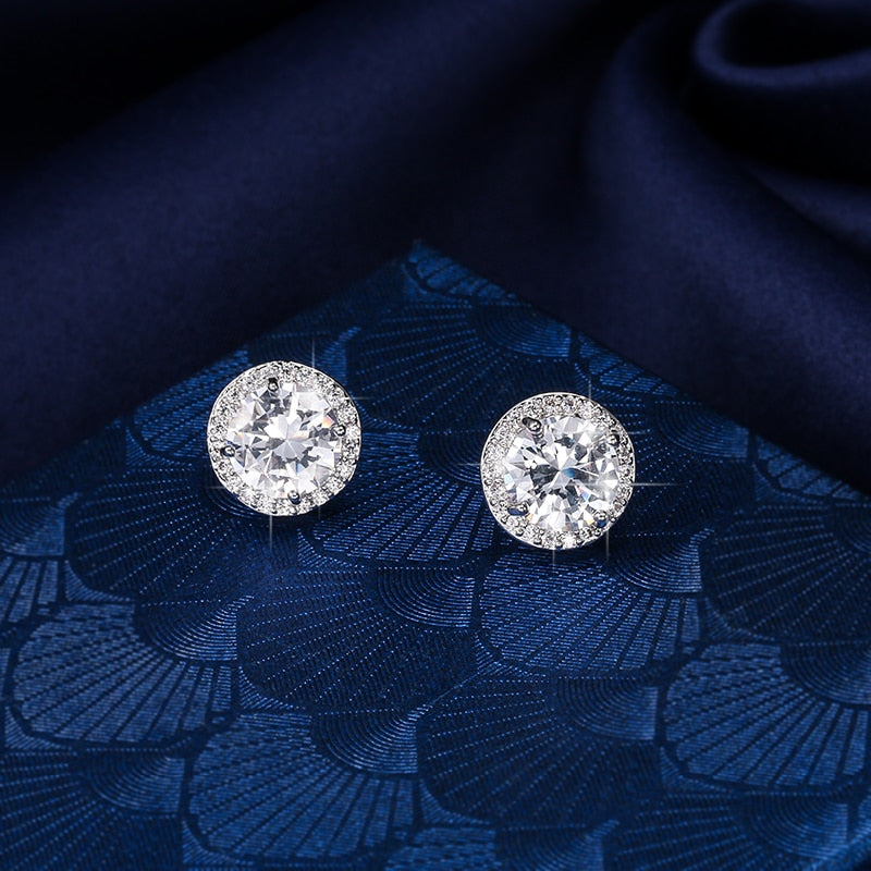 Close up of Sterling Silver Rhinestone Halo Studs against a blue chevron fabric.