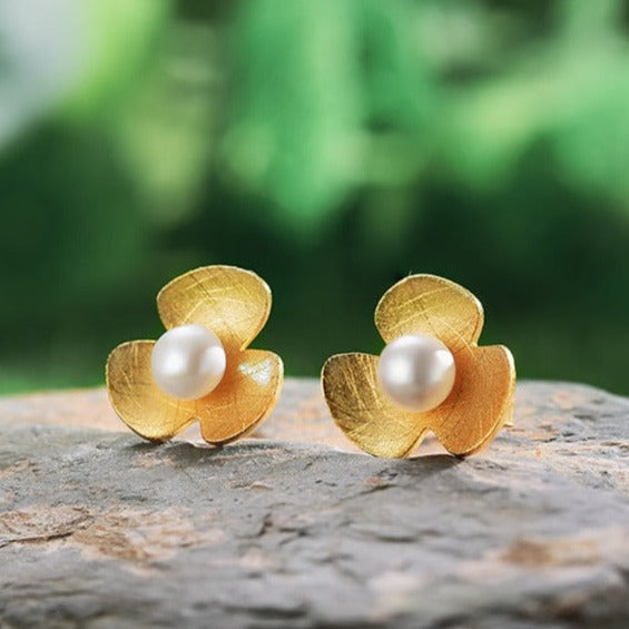 Close up of Lotus Studs resting on a stone from NAZ Parure Jewelry. 