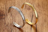Gold plated and stainless steel Wheat Cuff Bangle against wooden background.