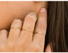 Woman wearing multiple gold filled rings including 14K Gold filled Flat Disc Band from NAZ Parure.
