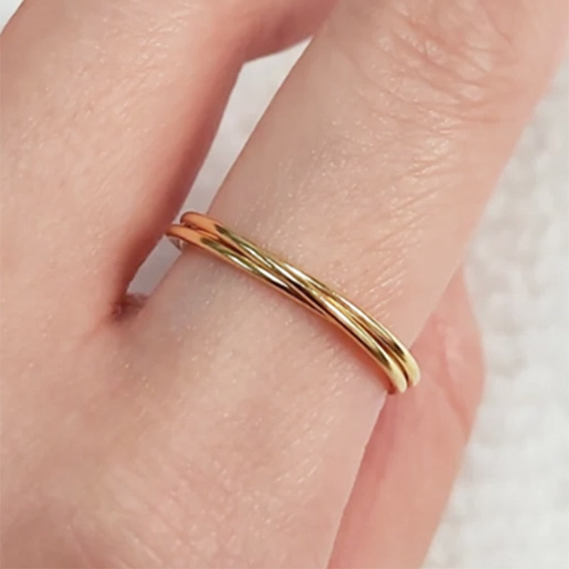 Woman wearing 14K Gold filled Trinity ring on index finger.