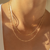 Woman outside wearing 14K gold-filled Fine Rope chain with sunshine hitting her neck. 