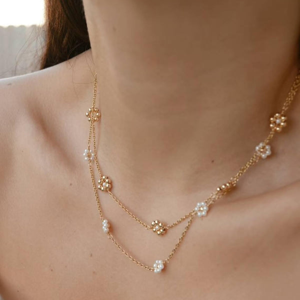 Woman wearing Pearl Daisy Necklace from NAZ Parure Jewelry