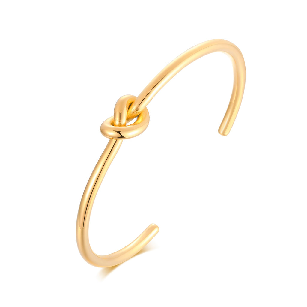 Gold plated Timeless Knot Cuff Bangle against white background.