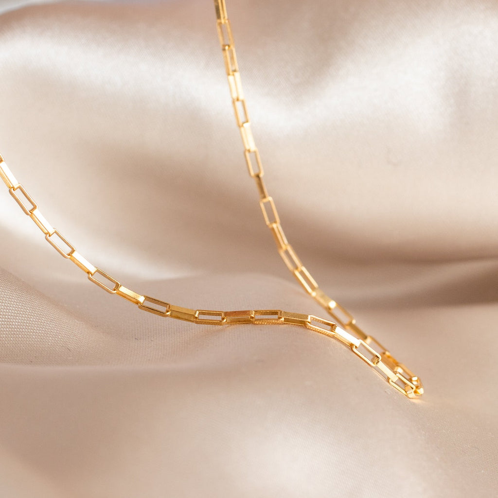 14K gold filled Chain Link Necklace showing dimension on peach satin fabric.